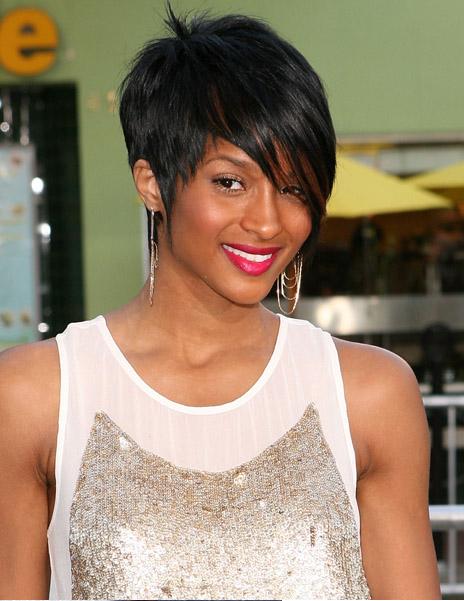 The hair is middle parted. Lob Hairstyle With Bangs Curly and super-sleek, 